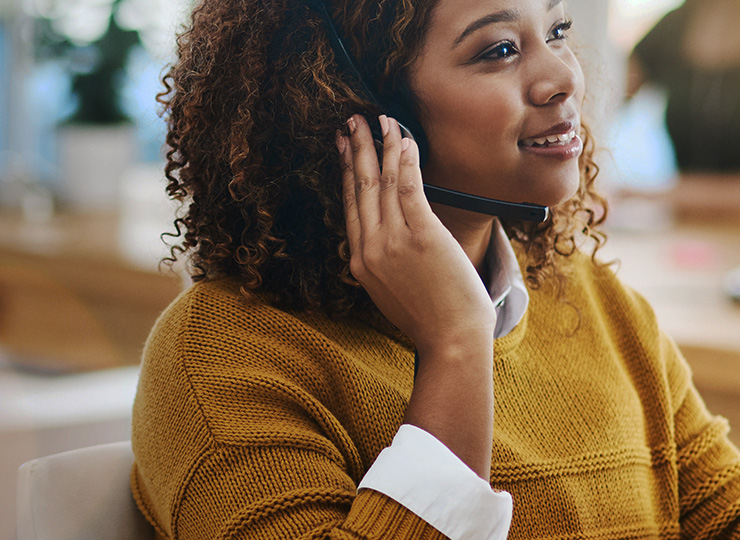 Female global travel service agent speaking on headset