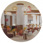 Hampton by Hilton Sharma's stylish lobby with multicoloured comfy chairs and tables.