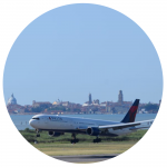 Delta aircraft on ground with Venice skyline in background