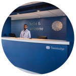 Travelodge employee stood behind a check-in desk
